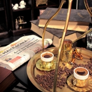 Authentic Greek coffee ritual with rich kaimaki, served in traditional cups on a brass tray with a briki.