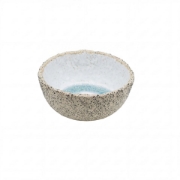 A small, artisanal stoneware bowl with a textured black-speckled cream exterior on a clean white background.