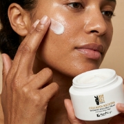 A close-up of Mastic Spa Donkey Milk cream being applied, showing its lifting effect