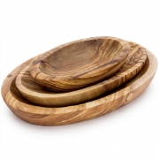 Set of three handcrafted olive wood oval dishes, nested together, with visible natural wood grain on a white background